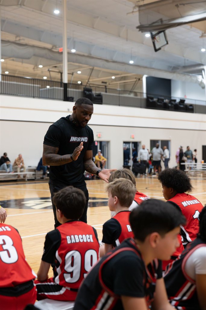 Coach Cel coaching EXOS players courtside